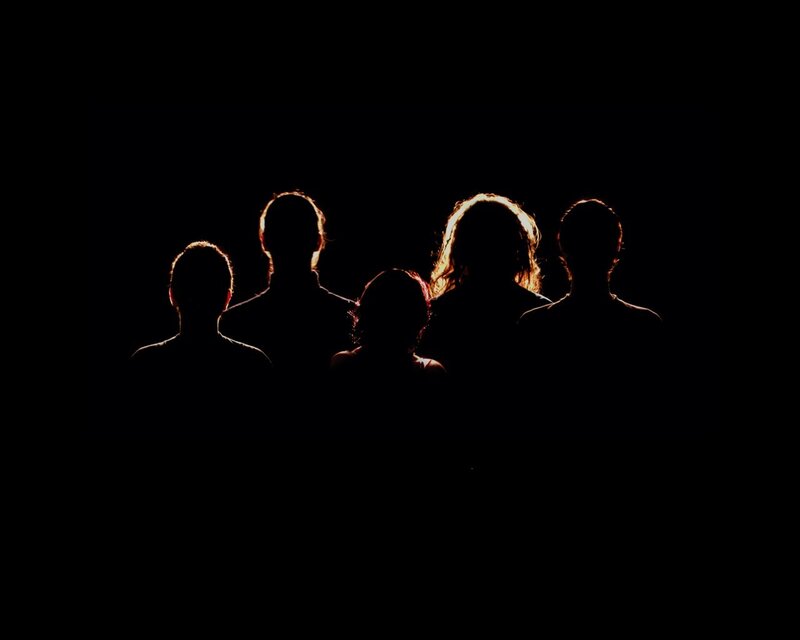 silhouettes of people in darkness
