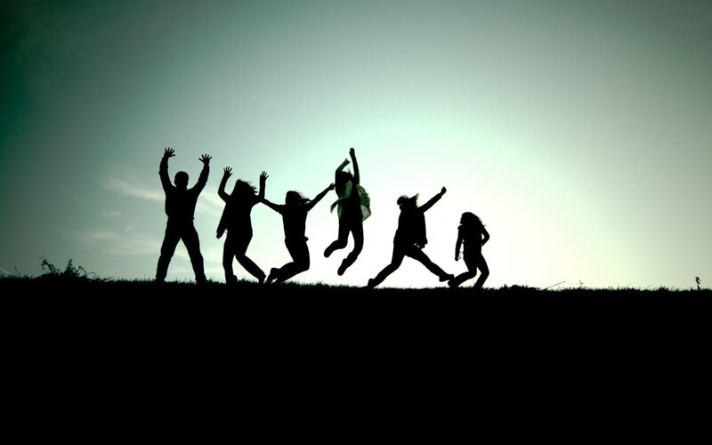 silhouettes of people jumping