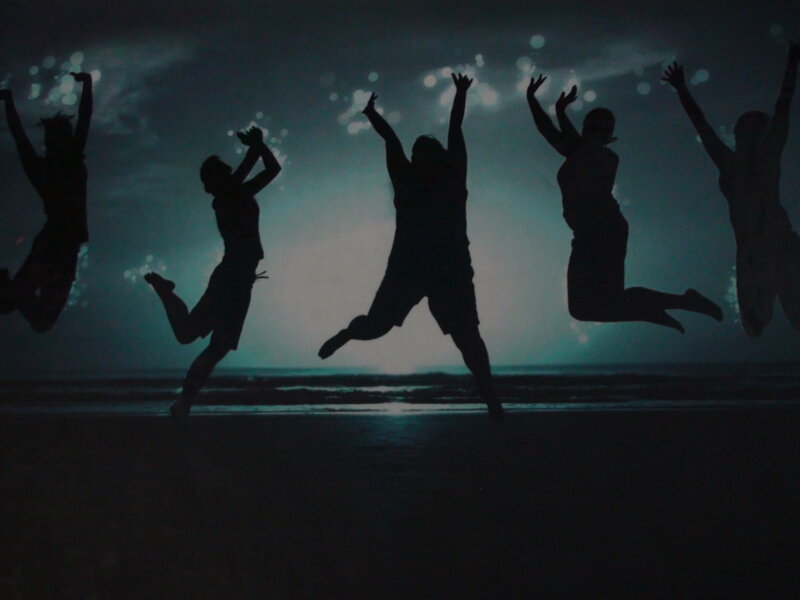 silhouettes of people jumping