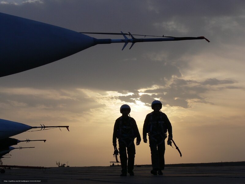 Silhouettes of pilots on tarmac