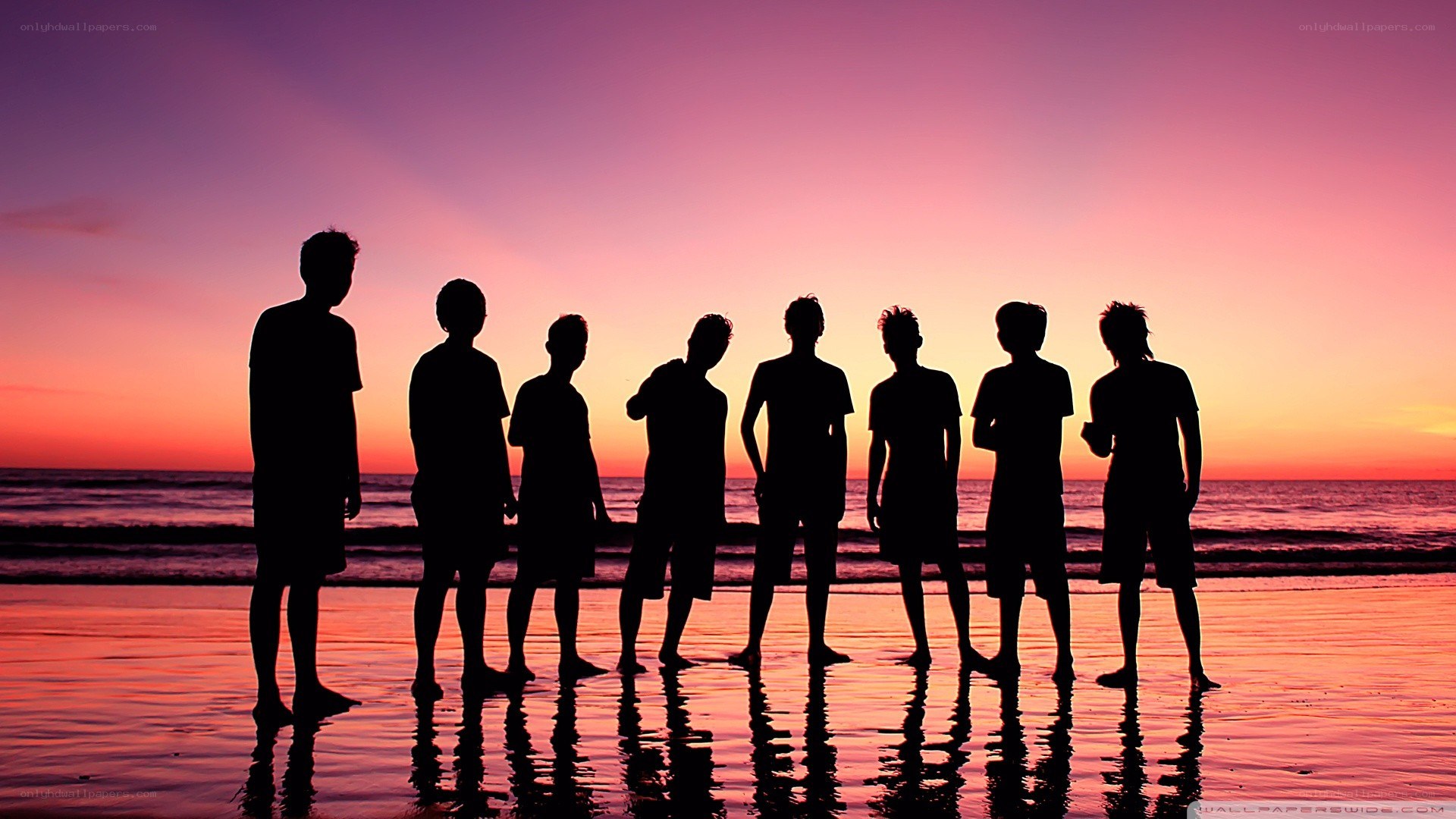 silhouettes on a beach at sunset