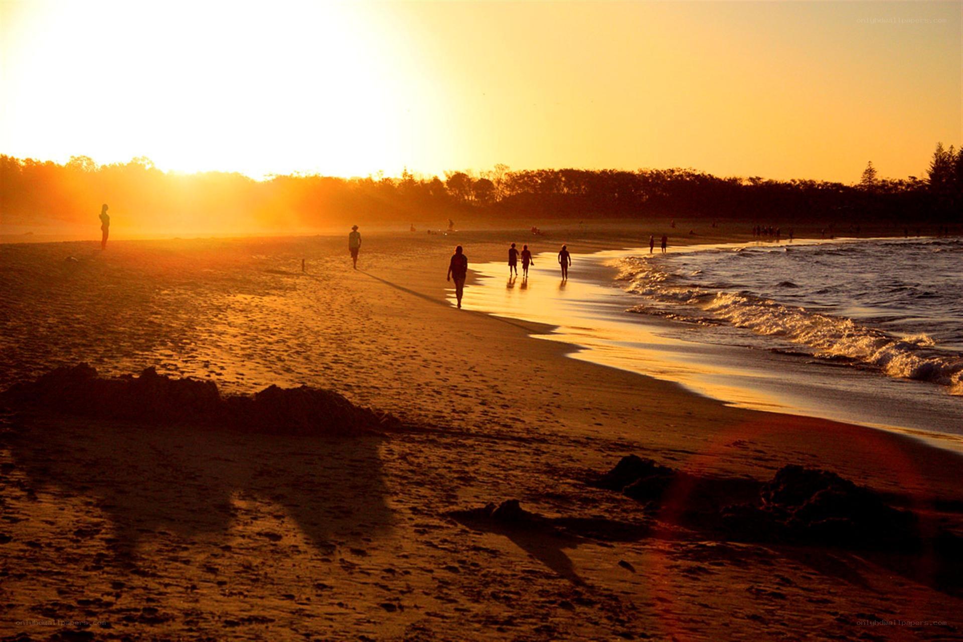 Silhouettes on a beach at sunset