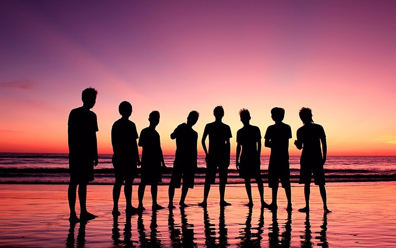 silhouettes on a beach at sunset