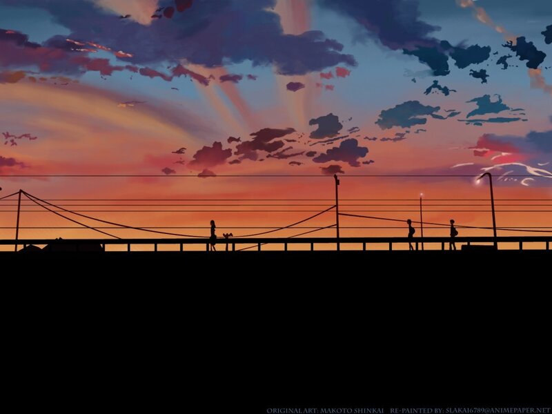 Silhouettes on a bridge at sunset