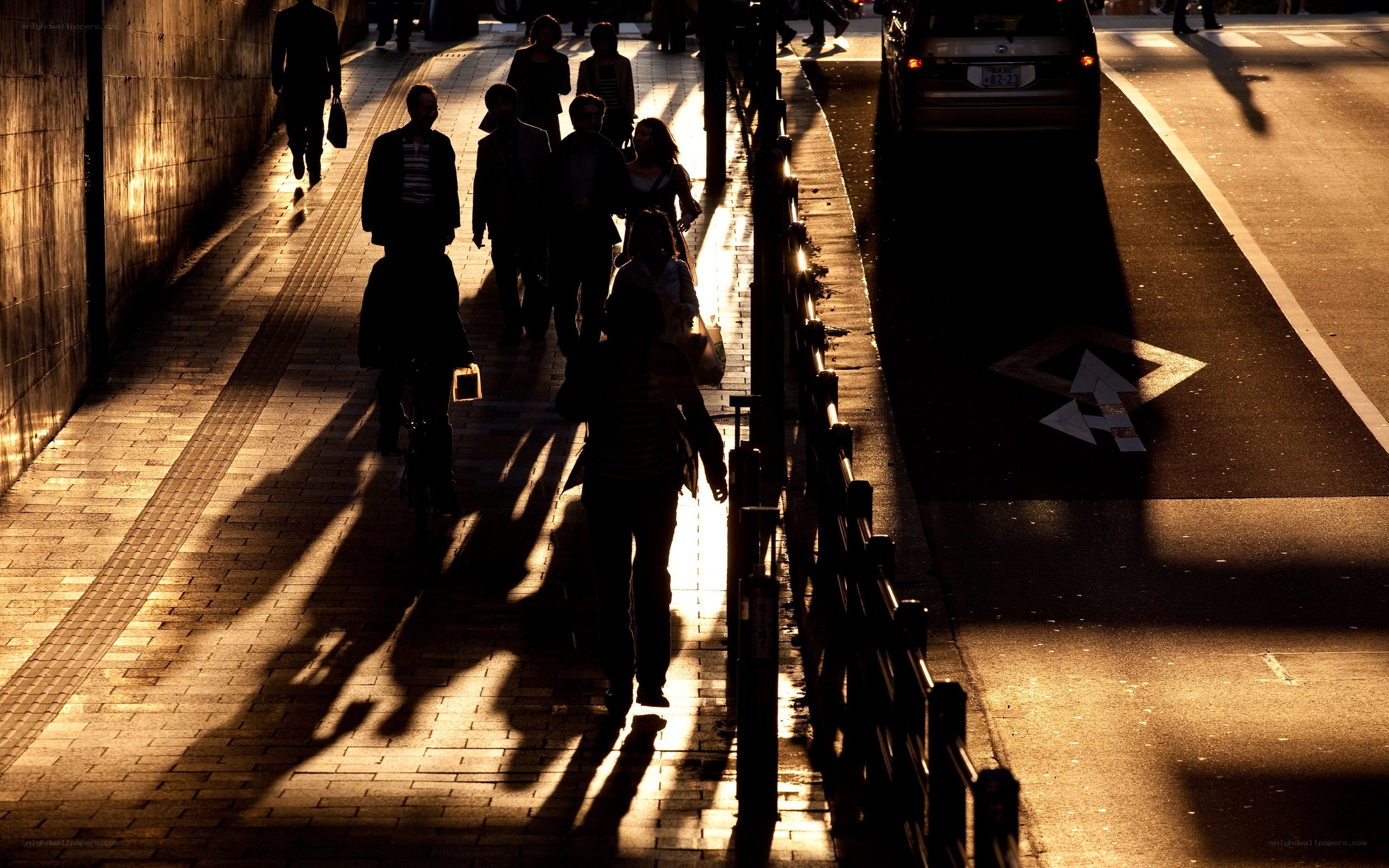 Silhouettes on a city sidewalk