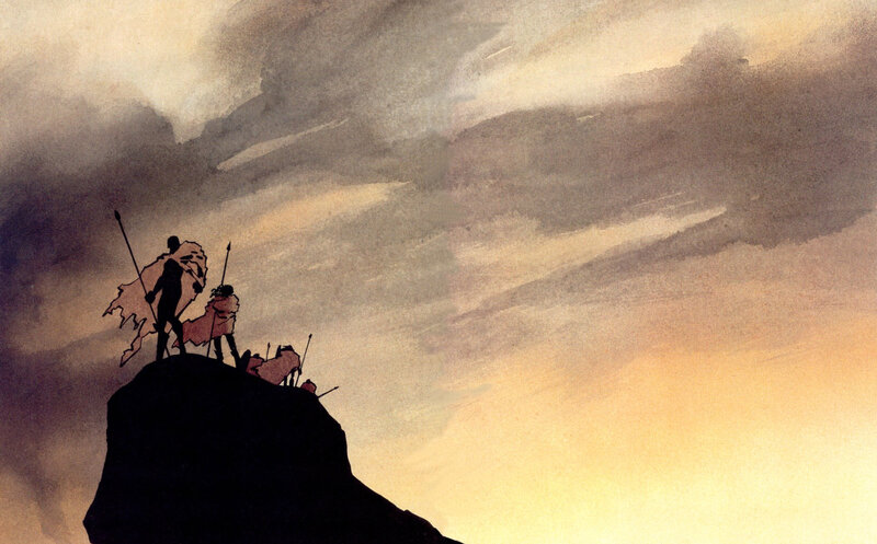 Silhouettes on a cliff at sunset