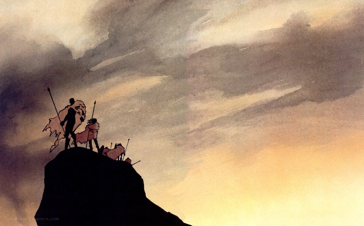 Silhouettes on a cliff at sunset