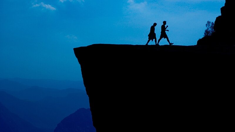 Silhouettes on a cliff edge