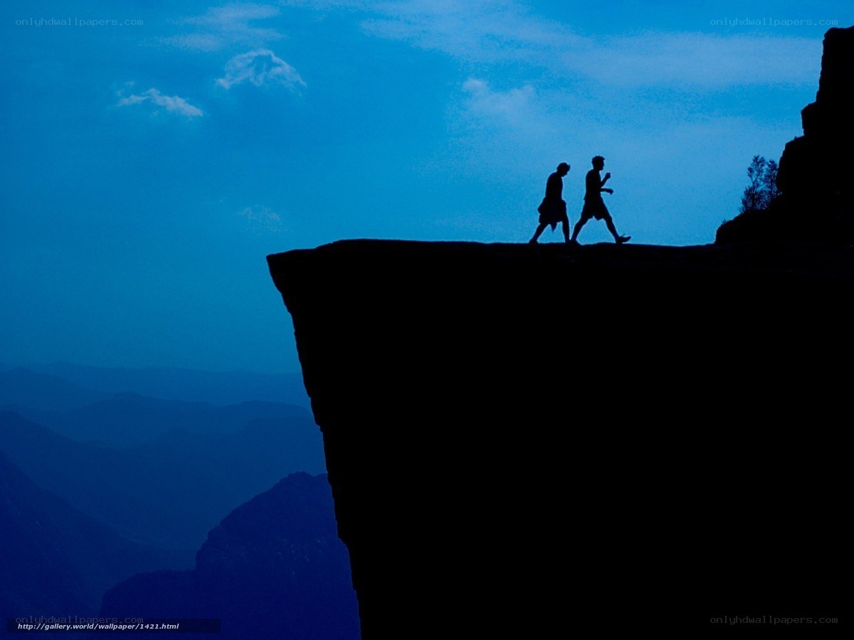 Silhouettes on a cliff edge