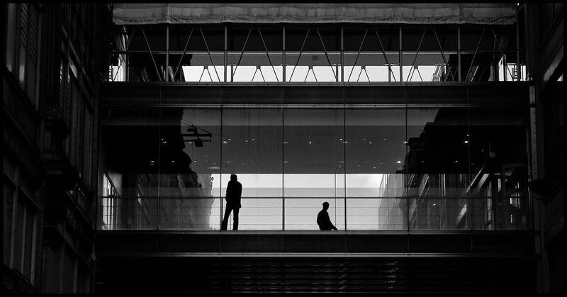 Silhouettes on a glass walkway