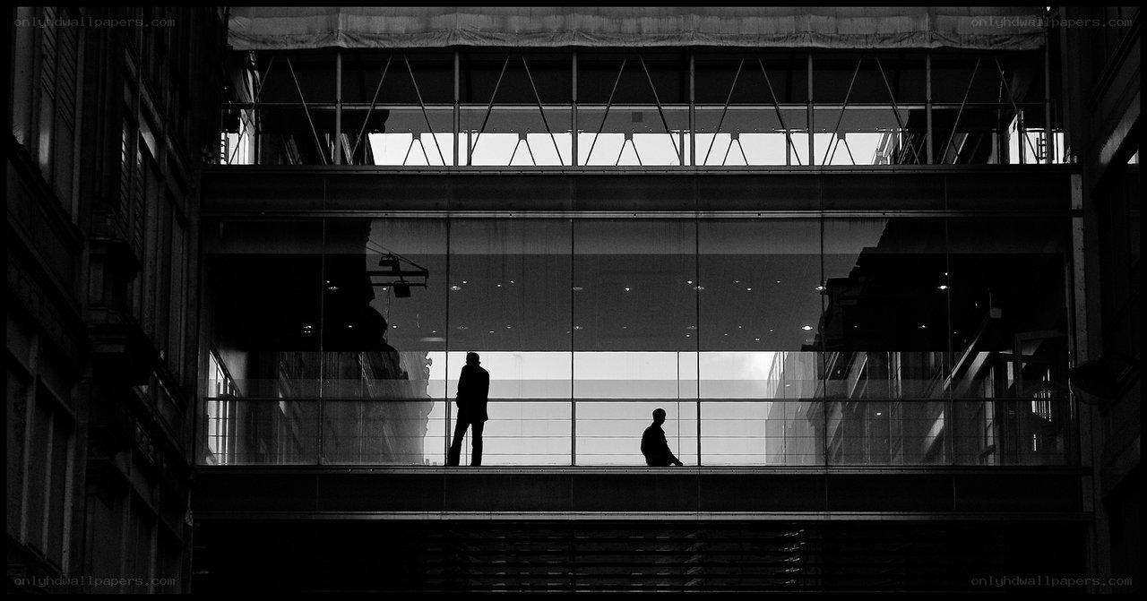 Silhouettes on a glass walkway
