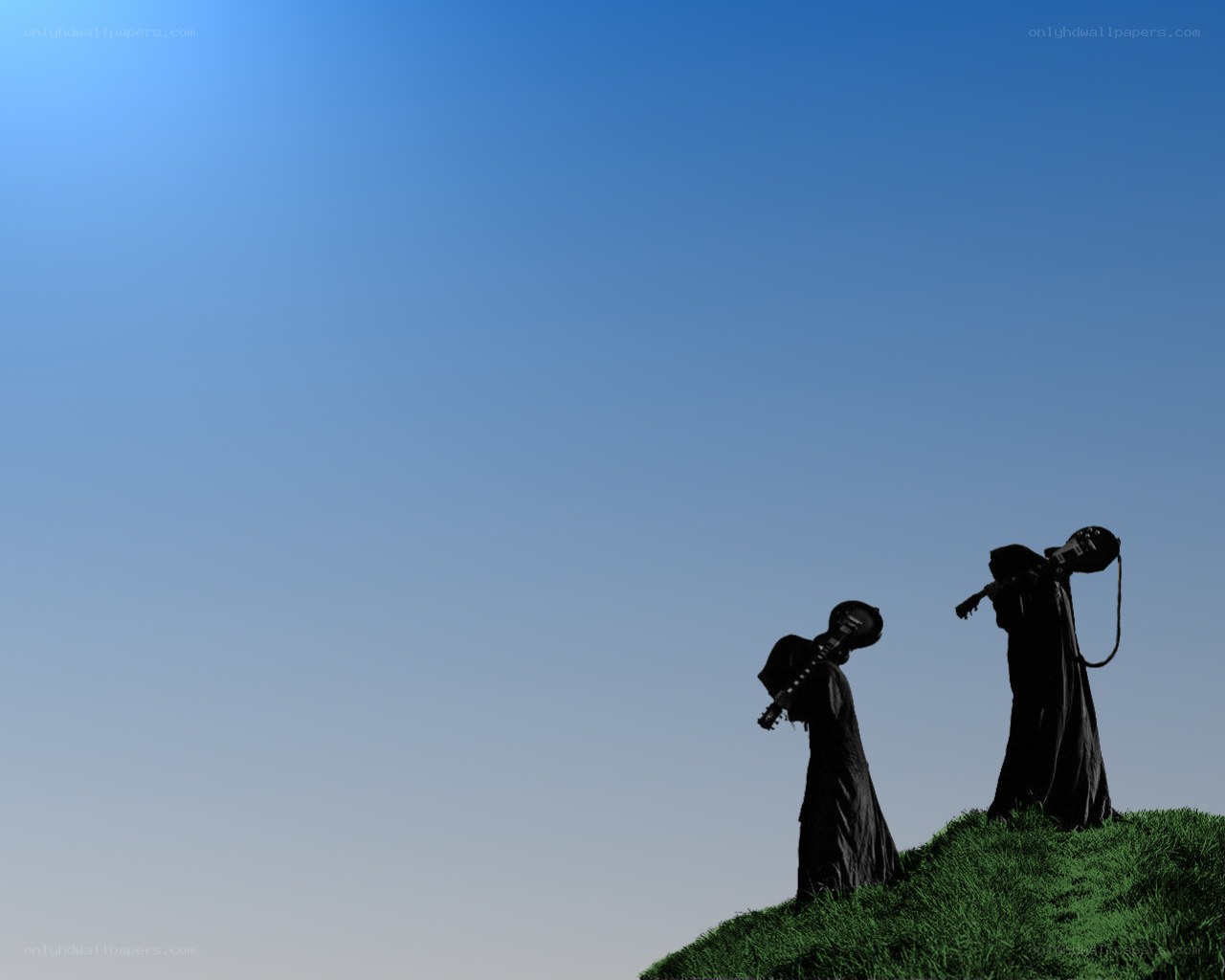 Silhouettes on a grassy hill