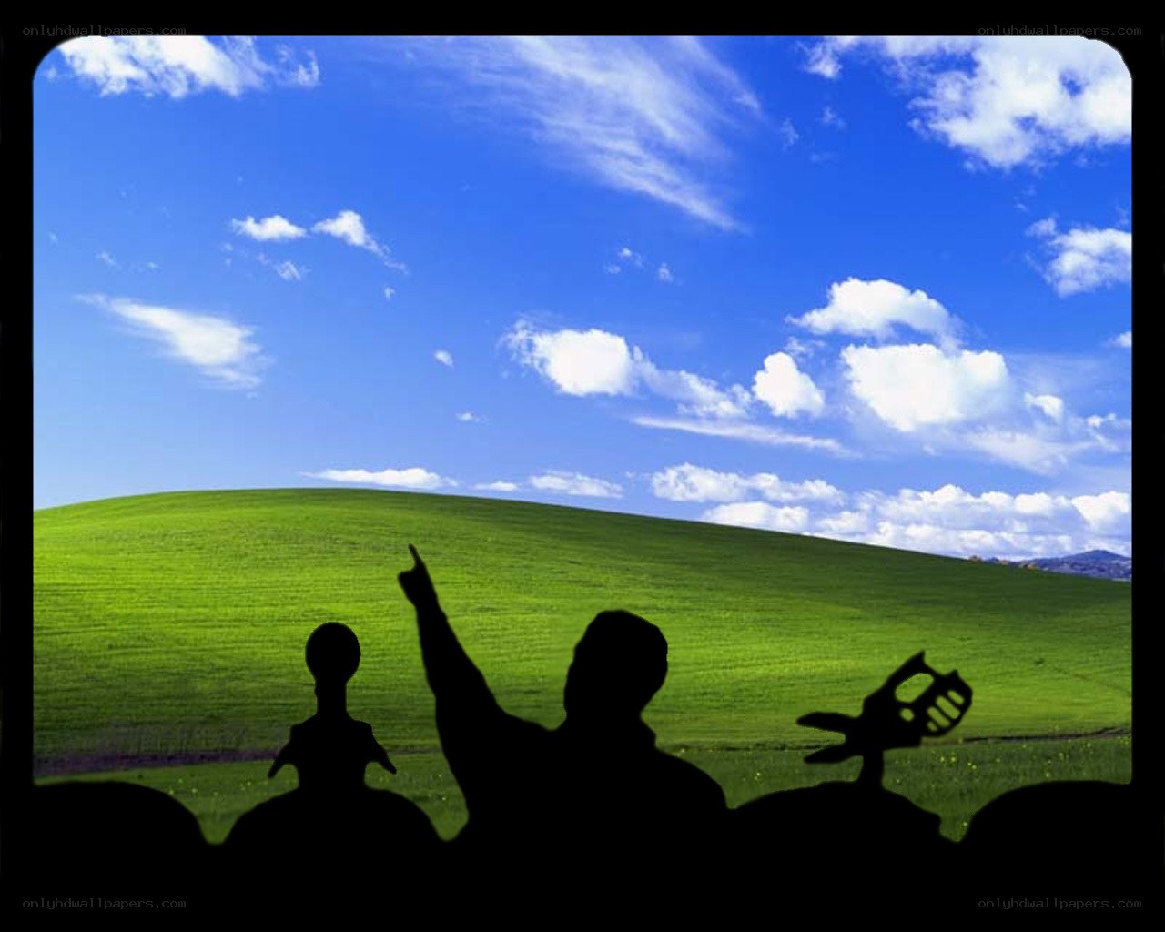 Silhouettes on a green hill