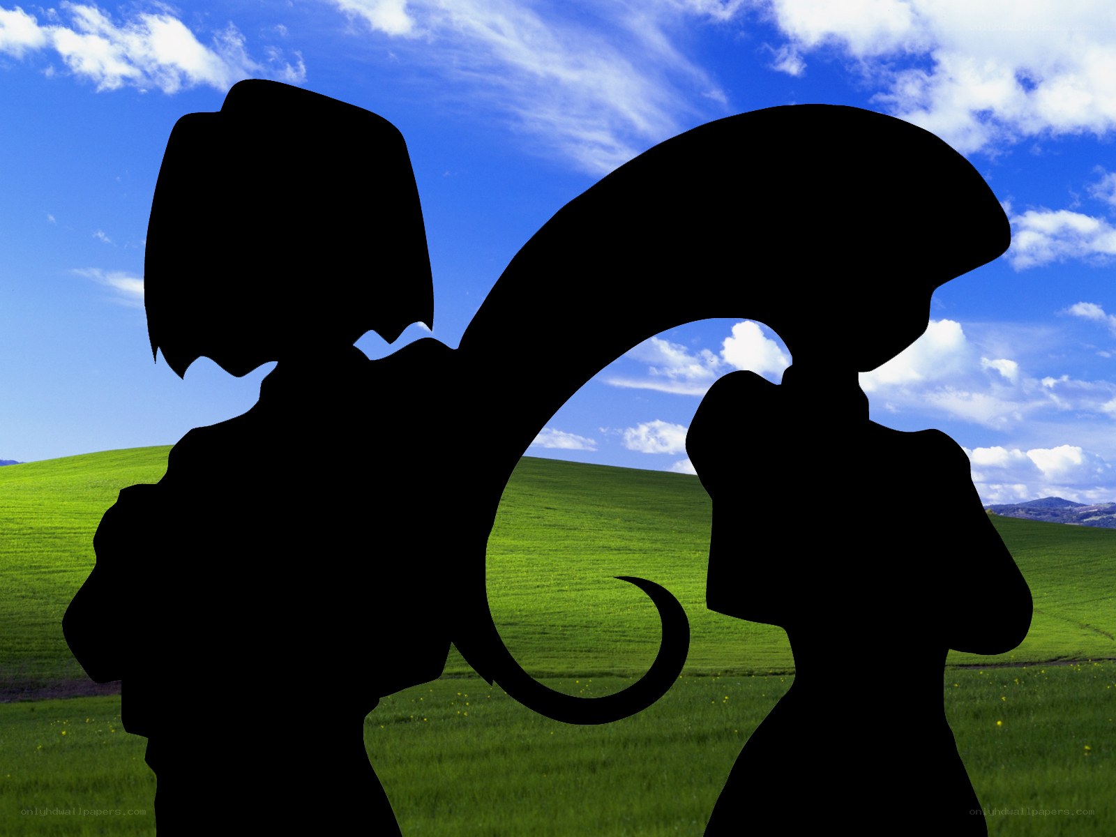 silhouettes on a green hill