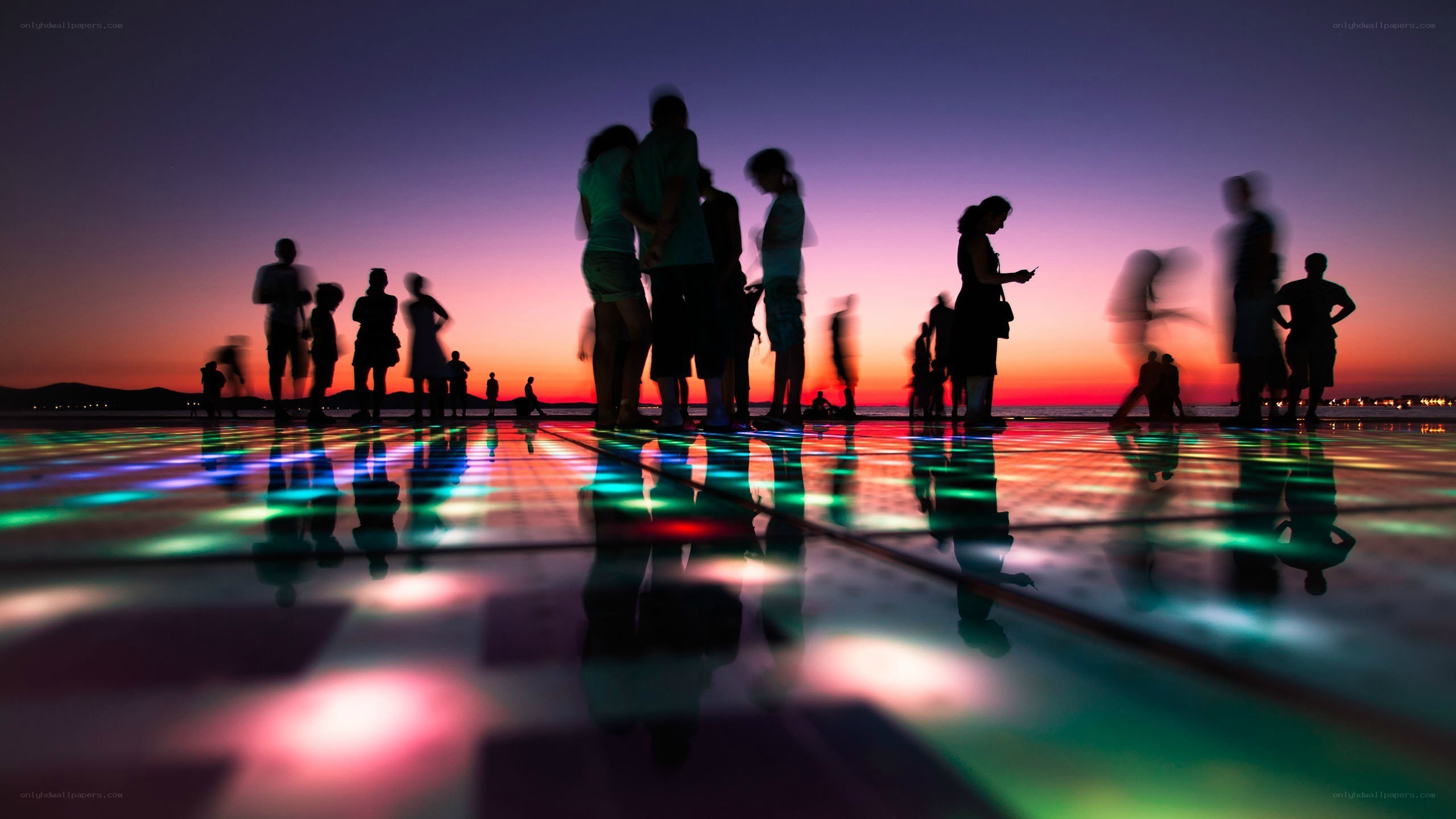 Silhouettes on a lighted floor at sunset