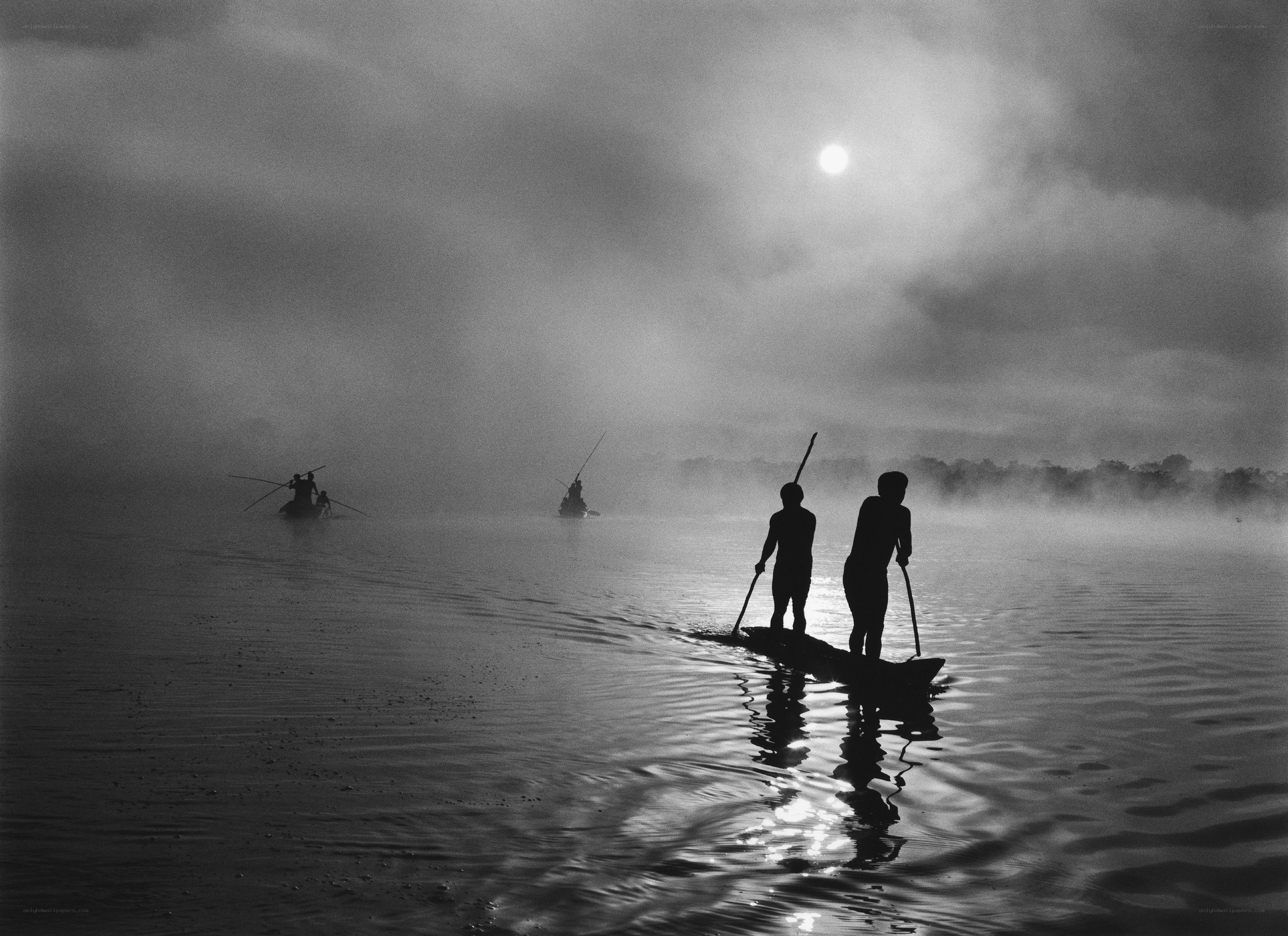 Silhouettes on a misty river