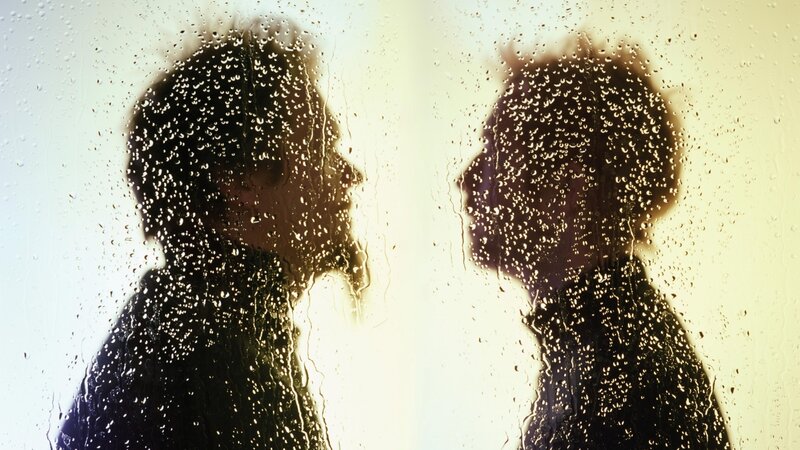 silhouettes on a rainy window