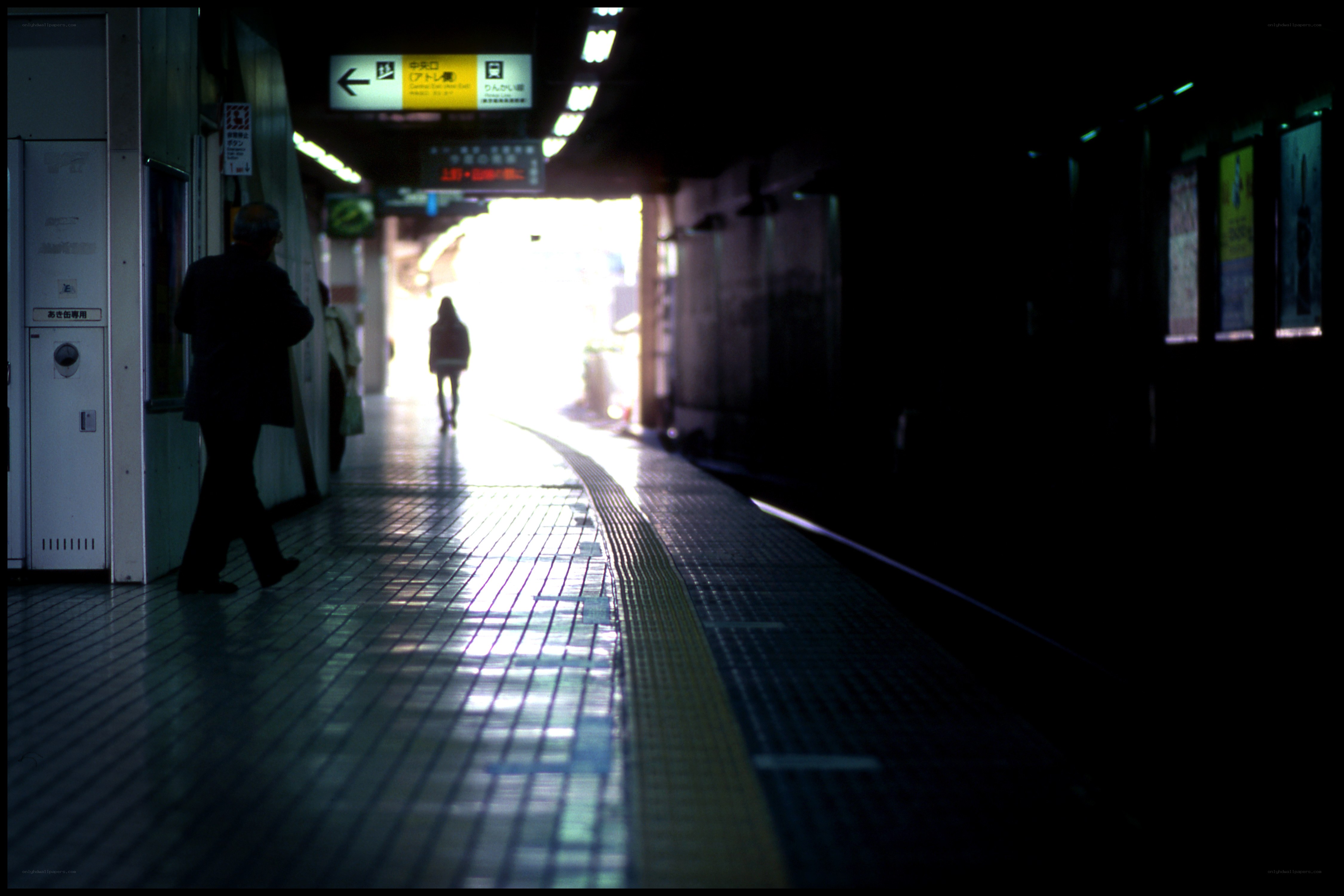 Silhouettes on a subway platform