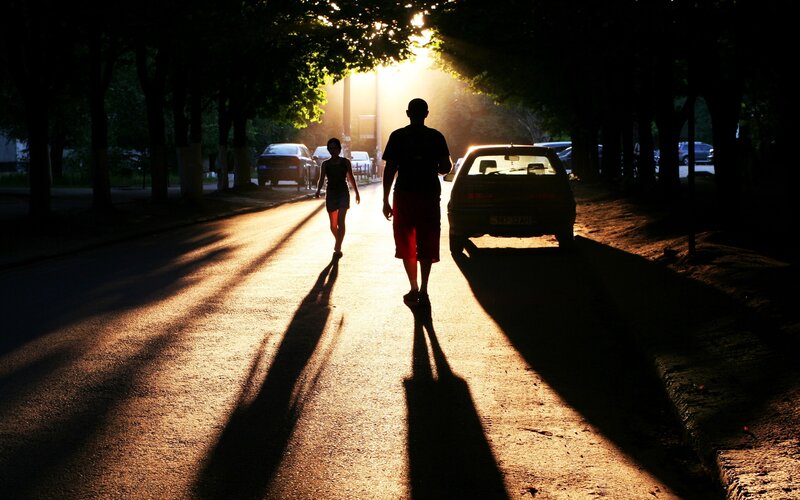 Silhouettes on a sunlit street