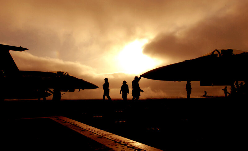 Silhouettes on an aircraft carrier deck