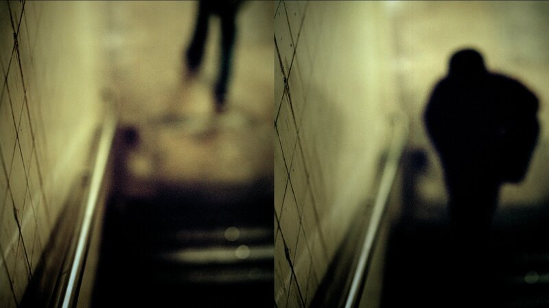 Silhouettes on an escalator