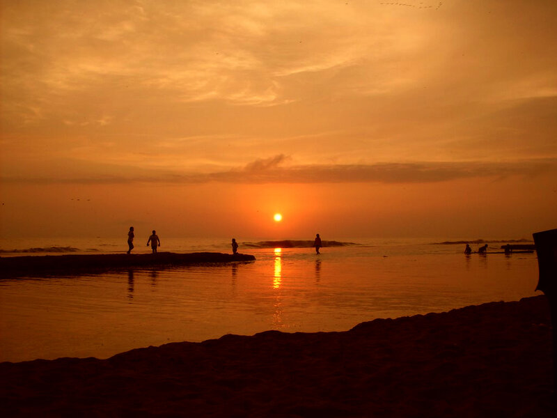 Silhouettes on Beach at Sunset — Orange, Serene