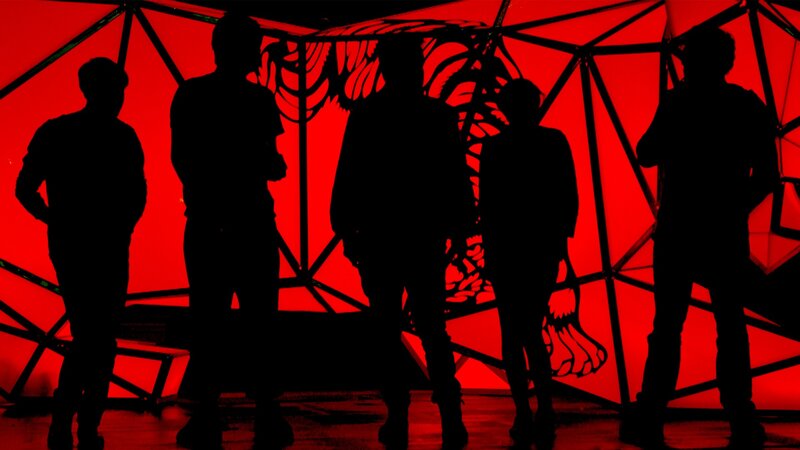 silhouettes on red stage