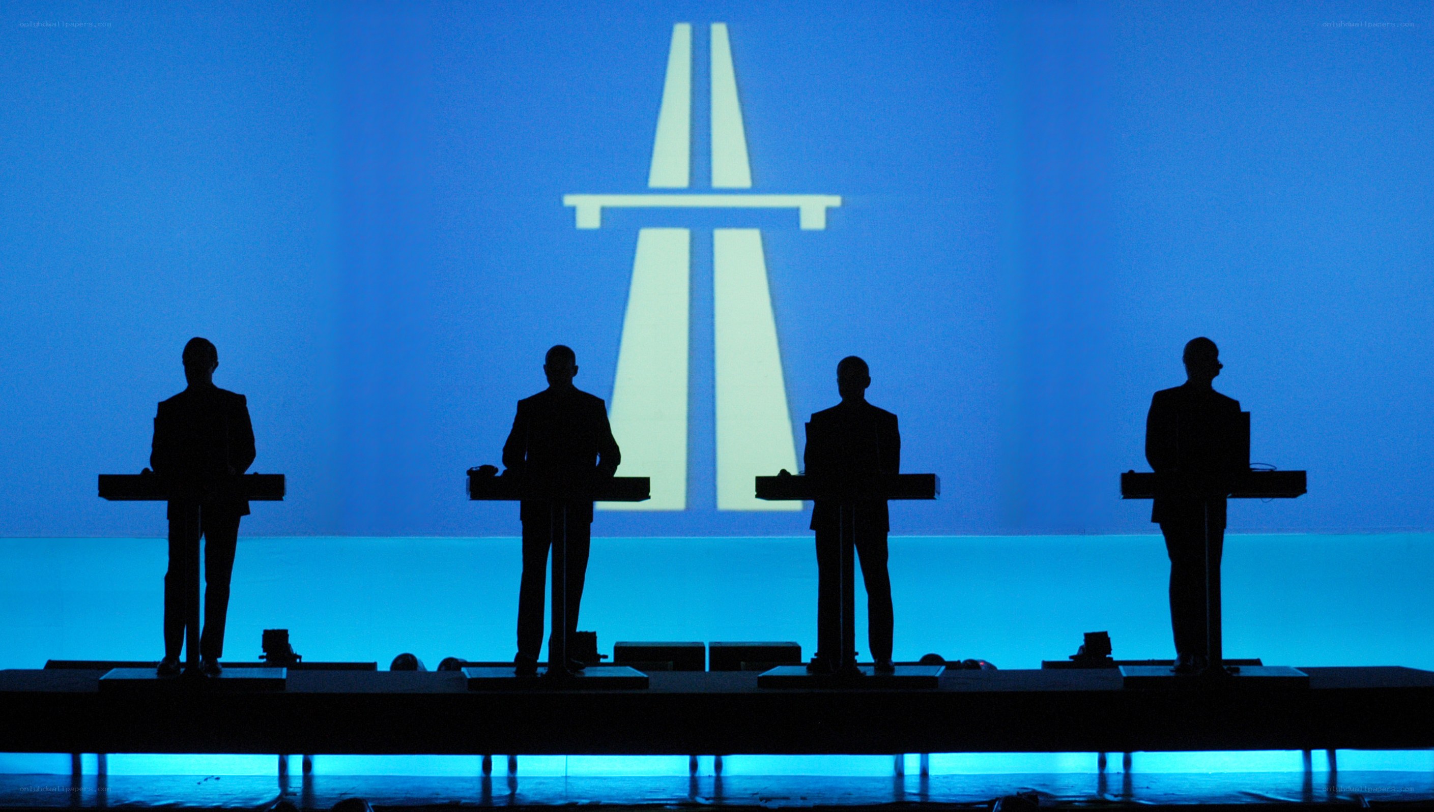 Silhouettes on stage with logo