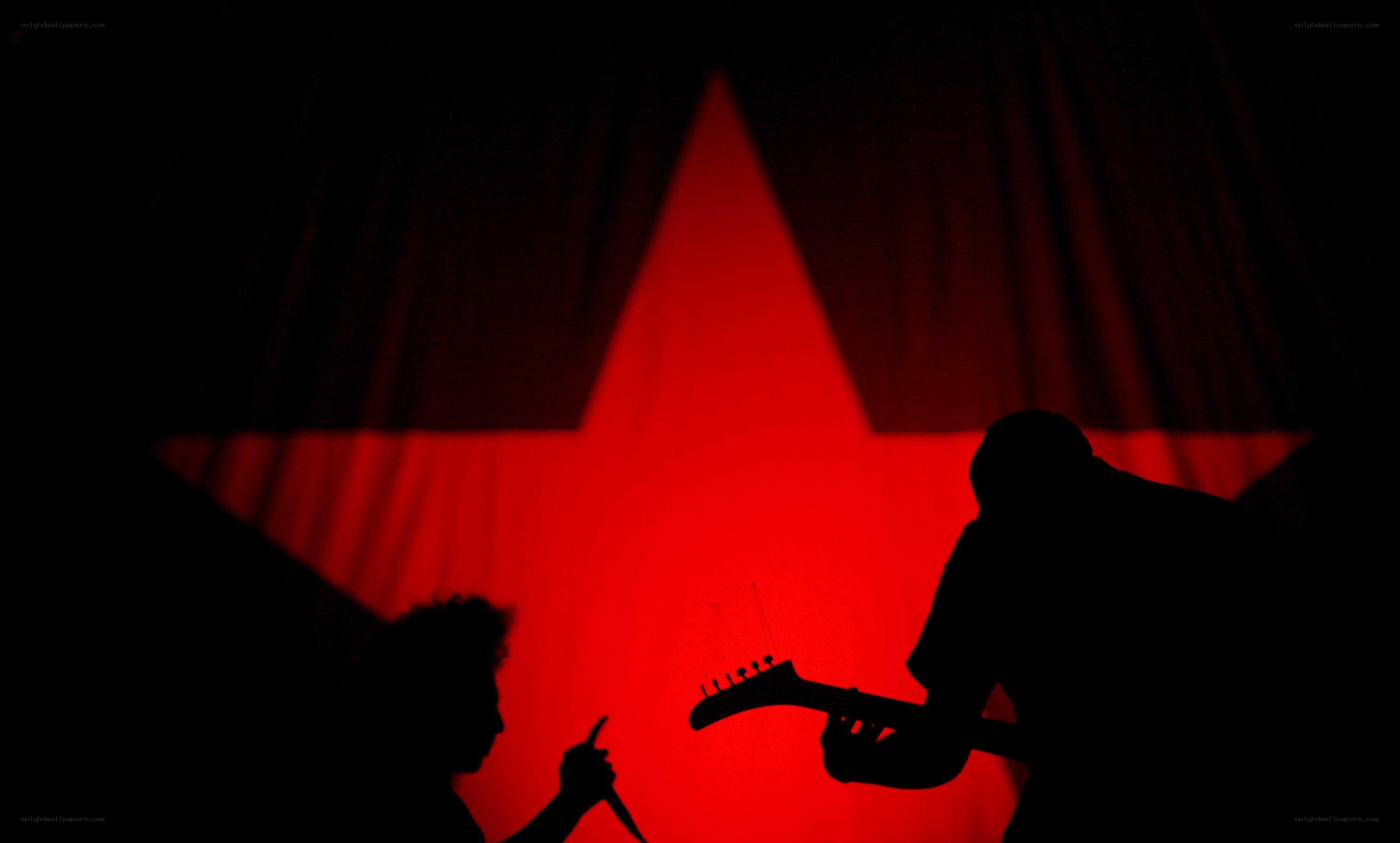 Silhouettes on stage with red star