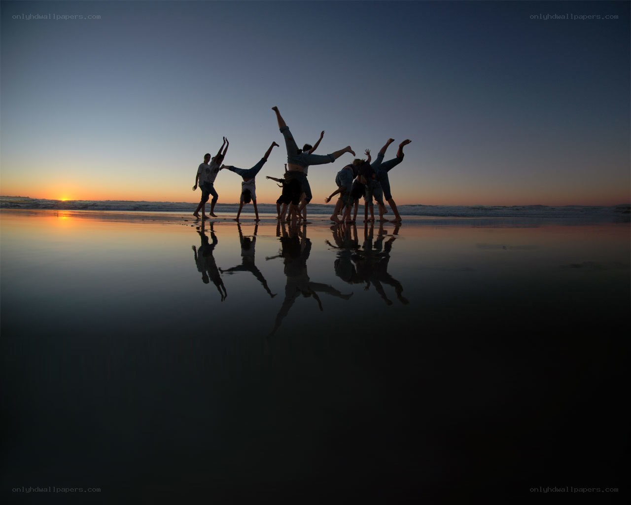 Silhouettes on the beach at sunset
