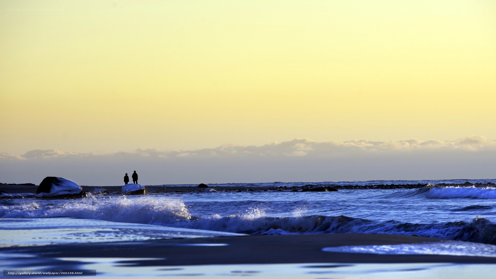 Silhouettes on the beach at sunset