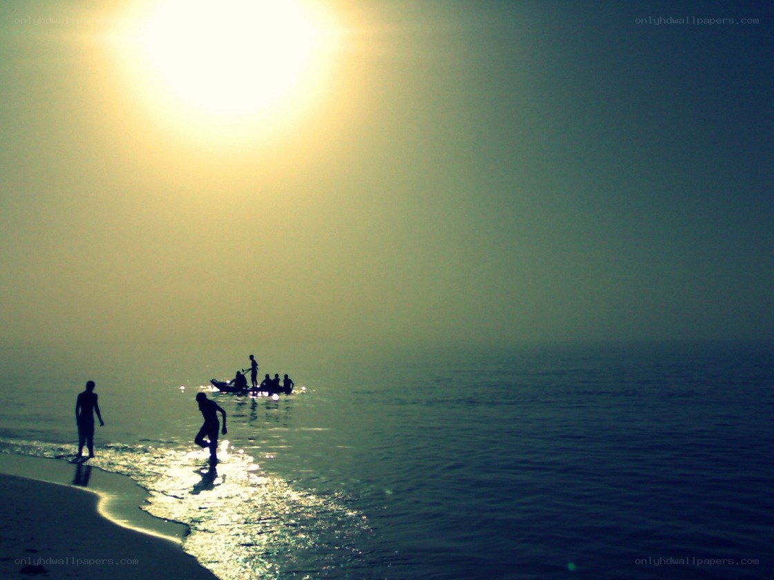 Silhouettes on the beach at sunset