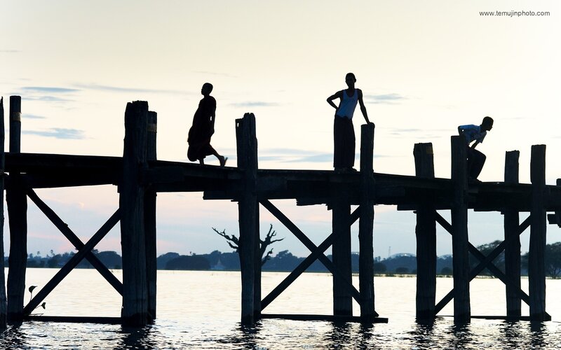 Silhouettes on Wooden Bridge
