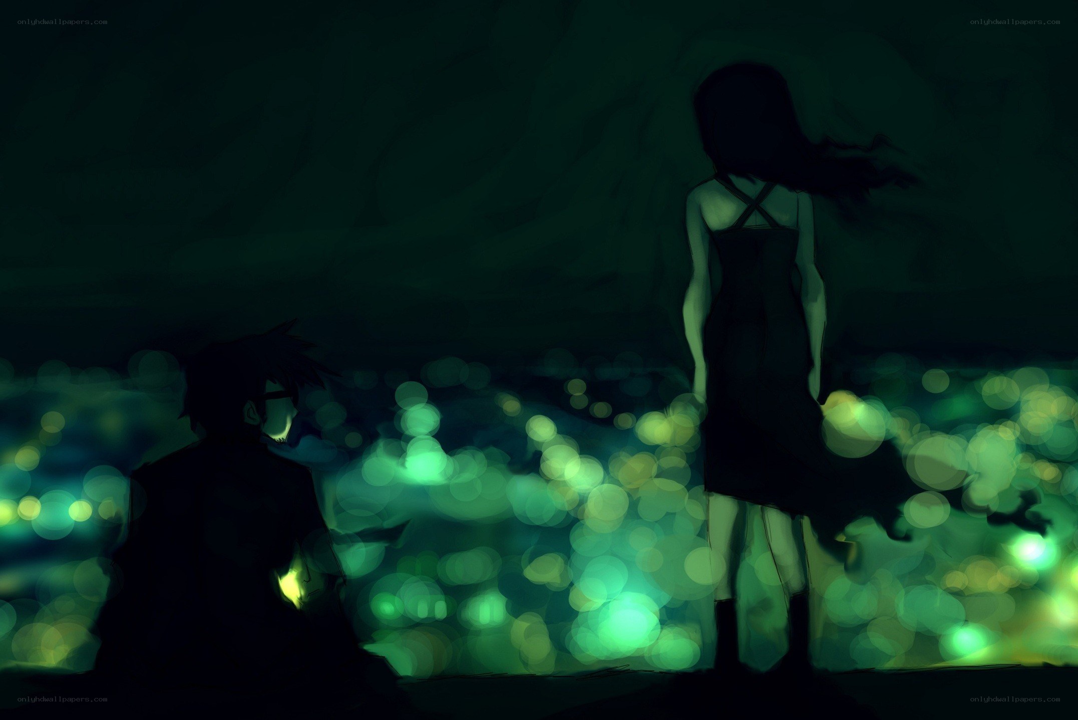 Silhouettes overlooking a glowing city