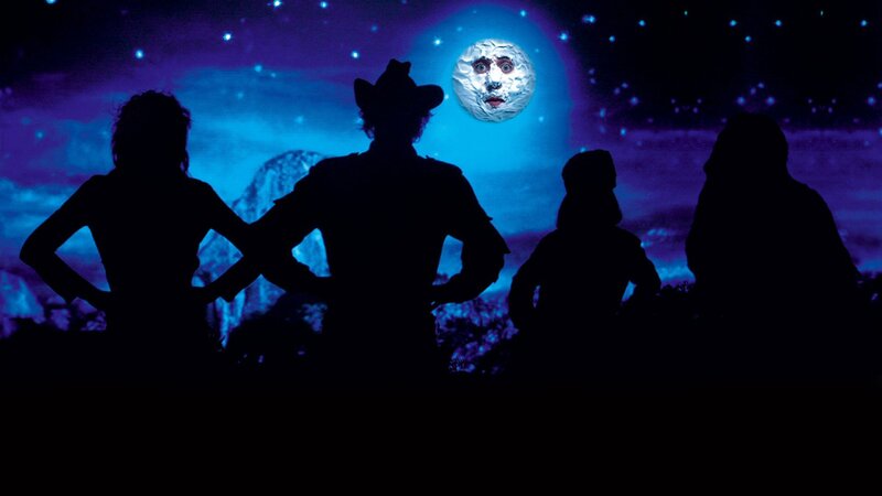 silhouettes under a moon face
