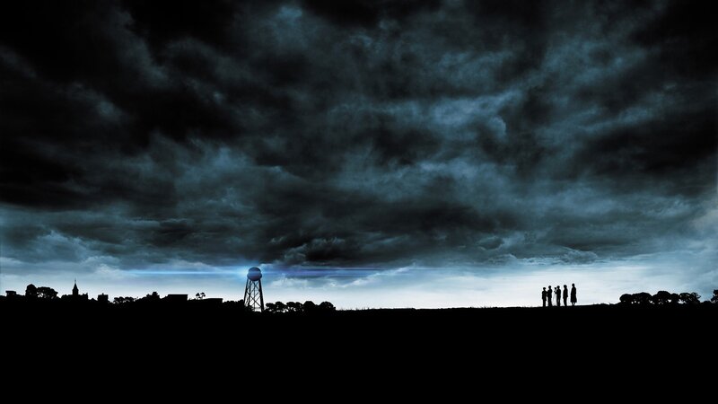 Silhouettes under stormy sky