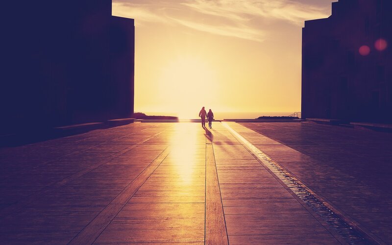 Silhouettes walking at sunset