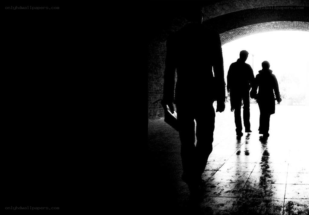 Silhouettes walking through tunnel