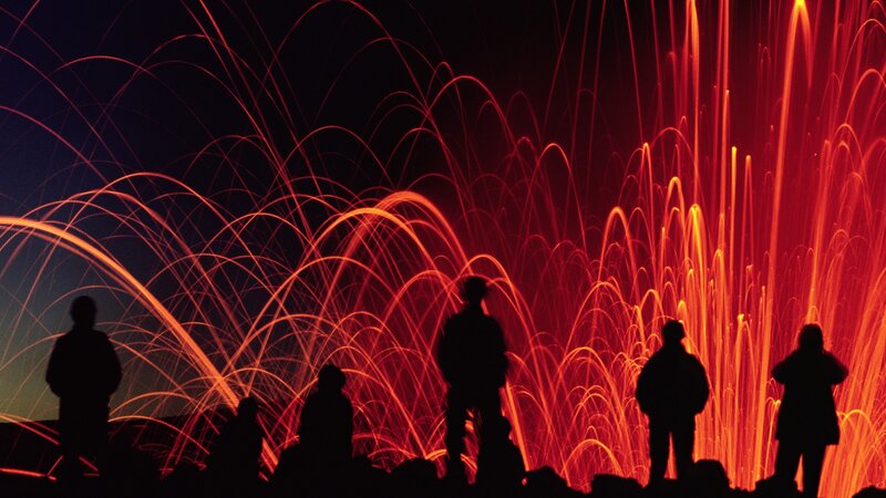 Silhouettes watching firework display