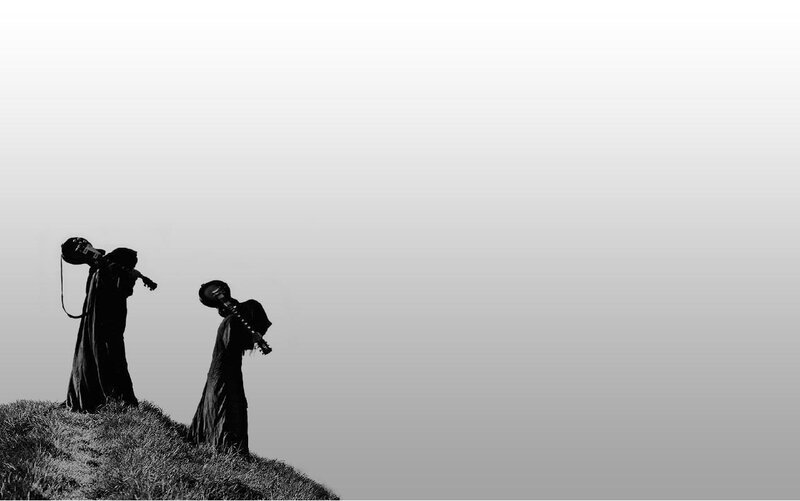 Silhouettes with instruments on a hill