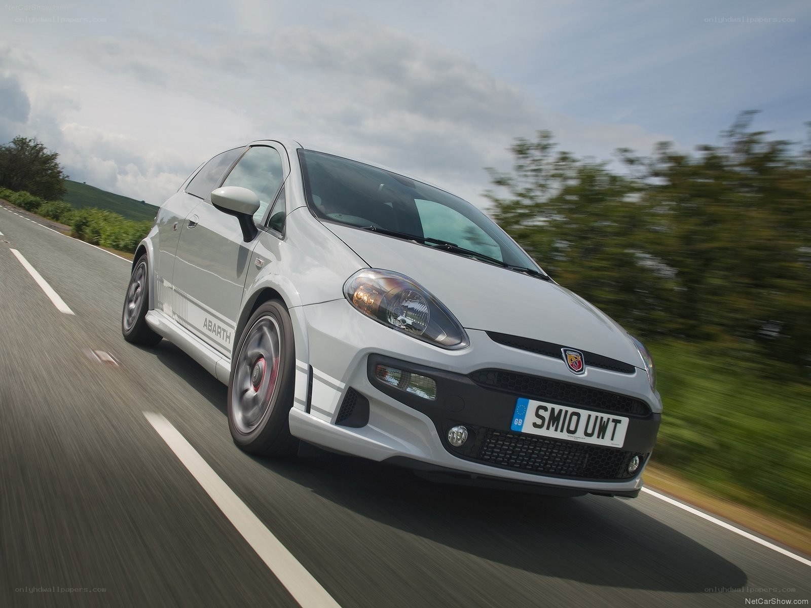 silver abarth on a country road