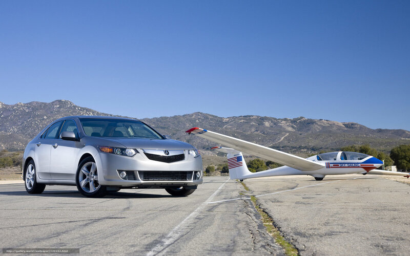 Silver Acura and glider on tarmac