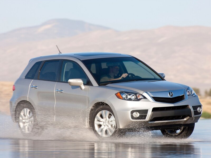 silver acura driving through water