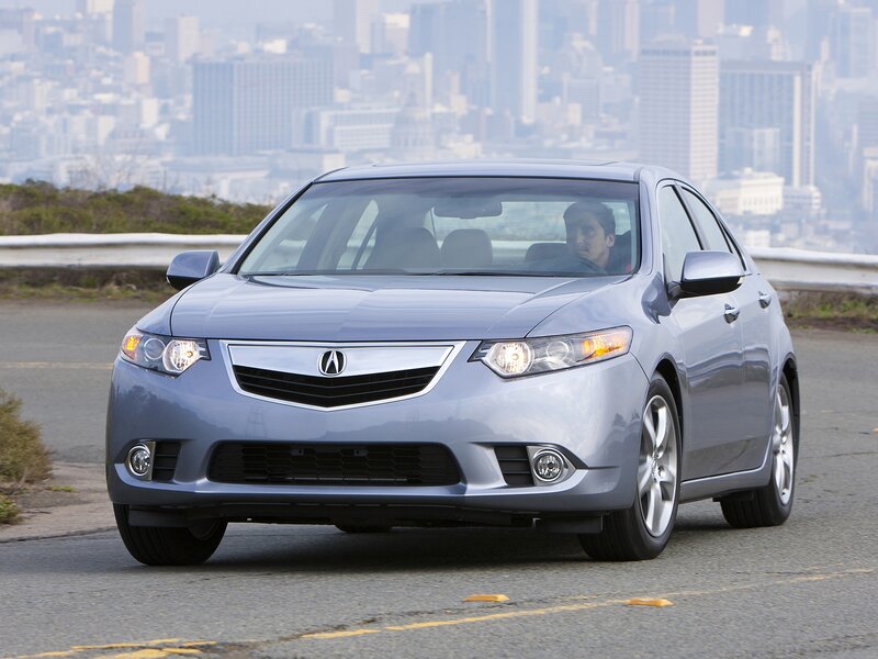 Silver Acura ILX on city road