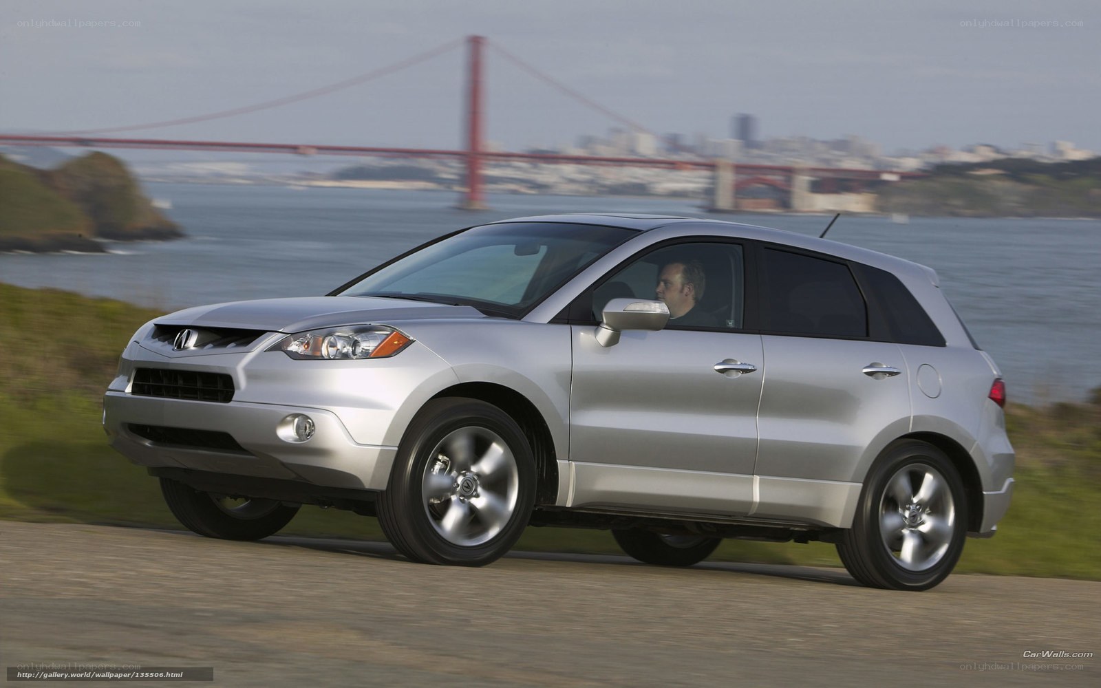 silver acura mdx driving by bay