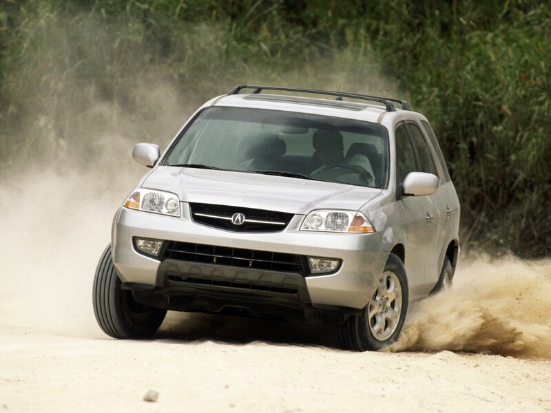 Silver Acura MDX driving on dirt