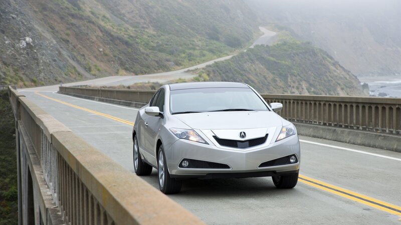 silver acura on coastal bridge