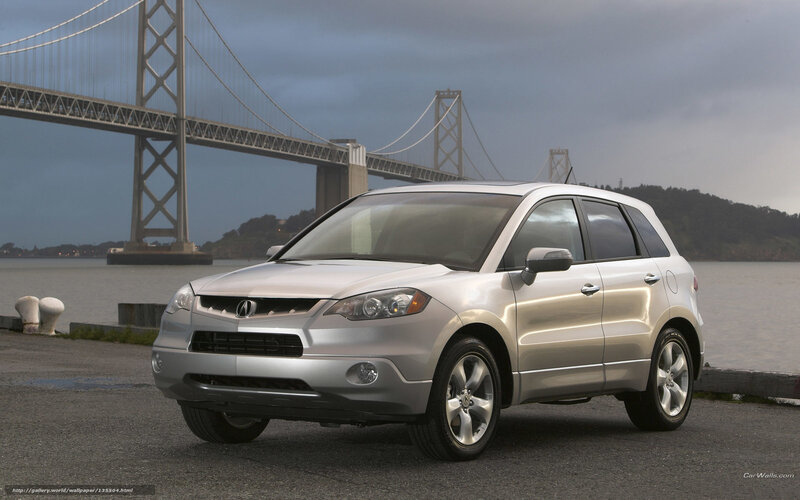 Silver Acura RDX by a bridge