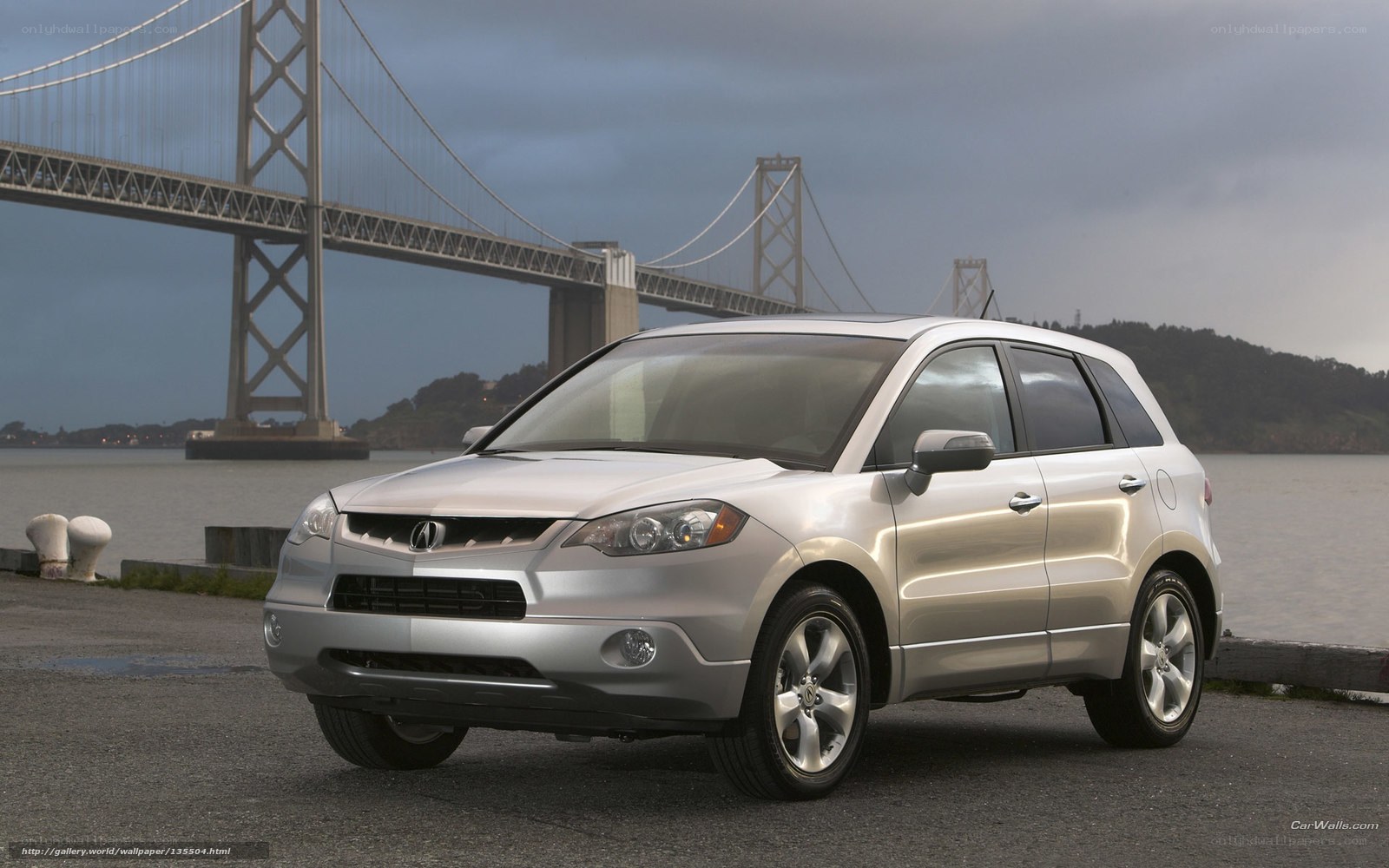 Silver Acura RDX by a bridge