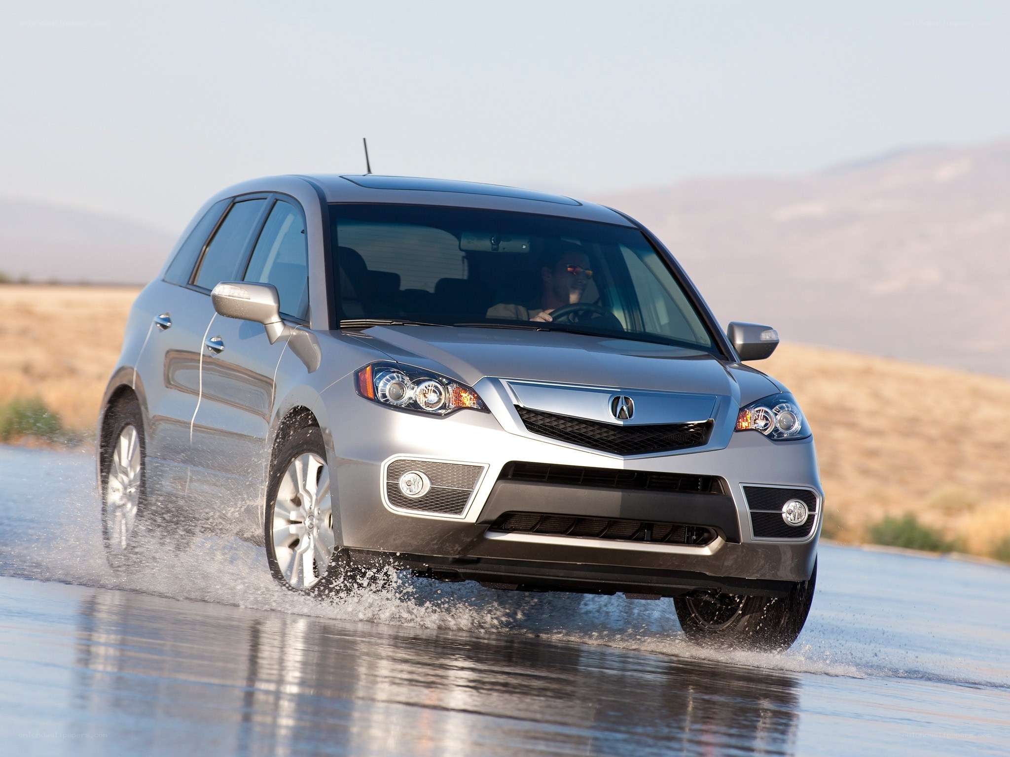 Silver Acura RDX driving through water
